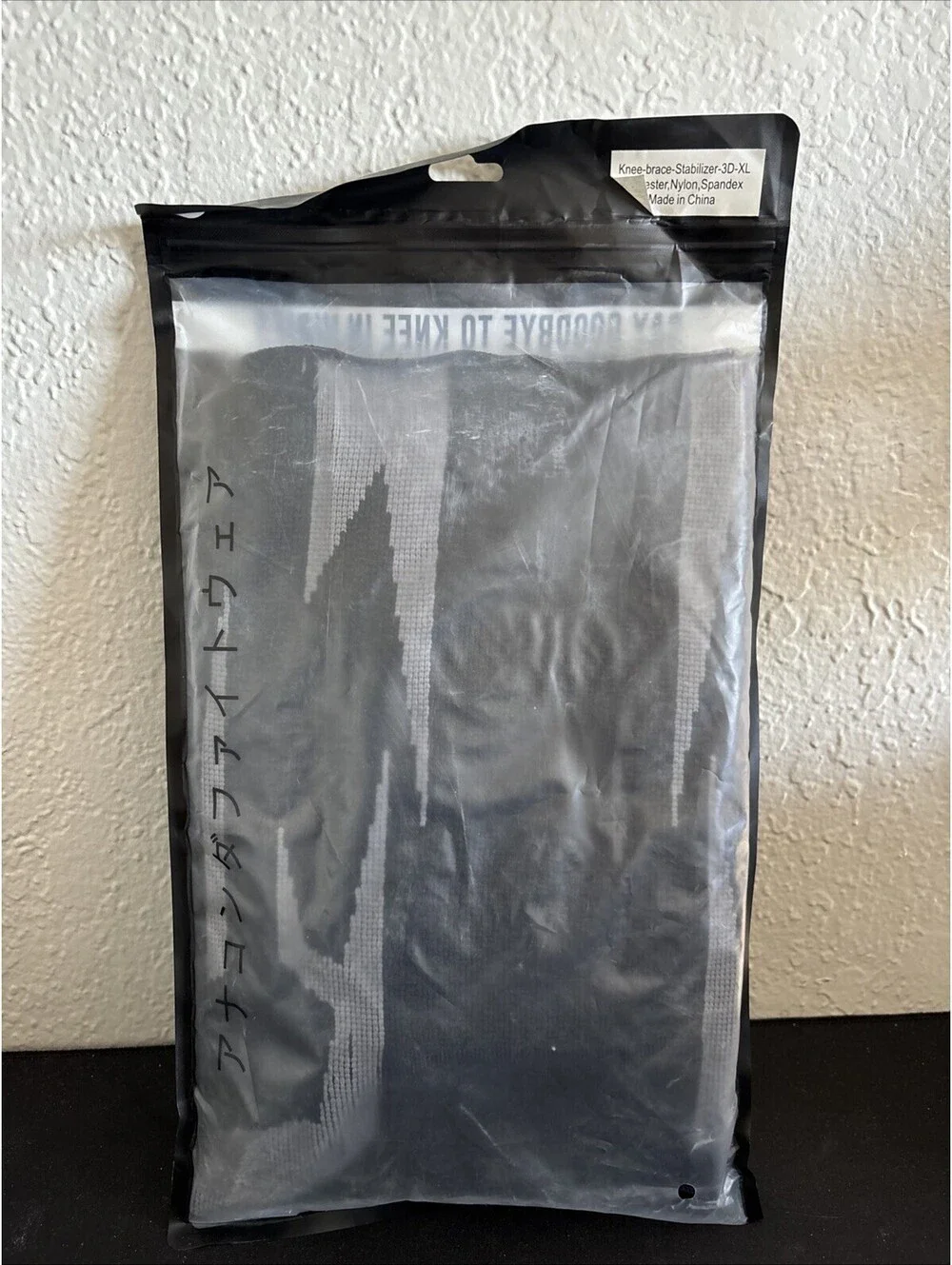 Anaconda brand knee brace featuring a black and gray textured design Size XL